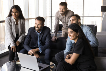 Diverse happy businesspeople teamworking on startup in informal office atmosphere