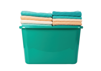 Isolated green wash basin full of colorful folded towels for clothes and linens household laundry