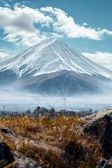 Majestic snow capped mountain under a cloudy blue sky