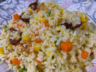 Fried rice with mixed vegetables on a plate close up shot