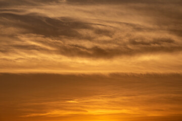 sunset in the clouds Presents a sky with orange and brown clouds, likely a sunset, no people....