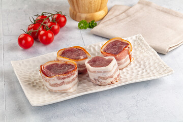 Raw pork tenferloin with bacon