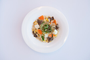 Savory Beef Fried Rice with Mixed Vegetables in a White Bowl