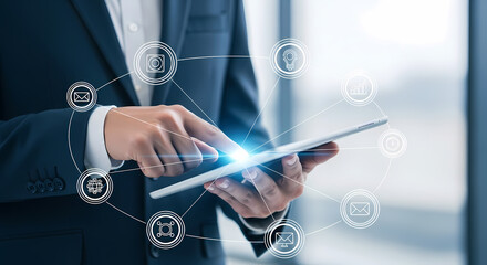 A business professional in a suit uses a digital tablet, showcasing modern technology and interconnected network icons for communication.