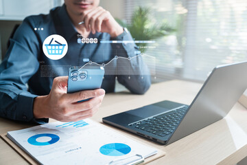 A businessperson managing e-commerce orders on a smartphone and laptop with digital analytics dashboard, representing sales tracking and online transaction management.