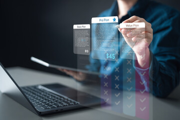 pricing, table, compare, plans, monthly, annual, tiers, A person comparing digital pricing plans on a holographic display, illustrating subscription tiers, features, and business offer selection.