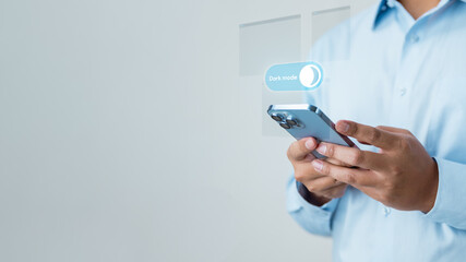 dark, mode, theme, appearance, ui, display, night, A person adjusting smartphone display settings to enable dark mode, representing UI customization, visual comfort, and battery saving preferences.