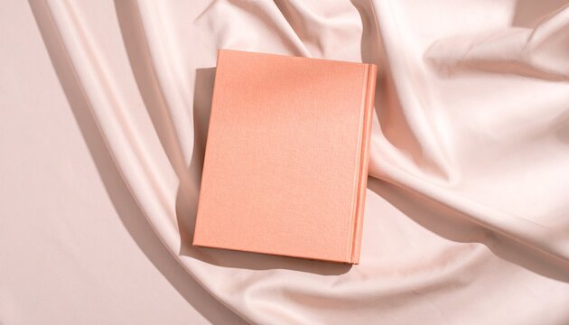 Peach Hardcover Book on Soft Fabric Background