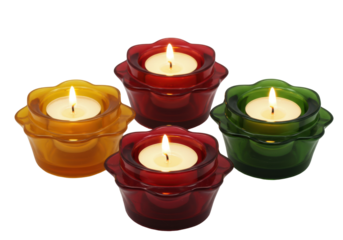 Isolated votive candles on a bright surface in orange, red and green hues - candlelit holders