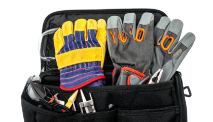 A close-up view of a black tool bag filled with work gloves and various tools