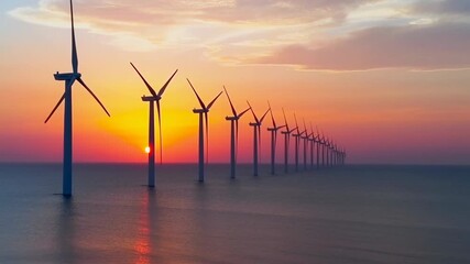 Offshore wind turbines generating renewable energy at sunset - Powered by Adobe
