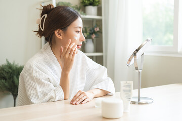Facial beauty skin care, smile of pretty asian young woman in bathrobe looking at mirror, hand...