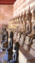 Golden ancient Buddha statue in a Lao temple with a serene meditation face, an iconic religious Asian sculpture representing peace and spirituality, Vientiane, Laos