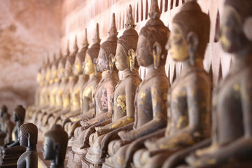 Golden ancient Buddha statue in a Lao temple with a serene meditation face, an iconic religious Asian sculpture representing peace and spirituality, Vientiane, Laos