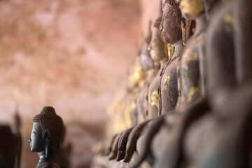 Golden ancient Buddha statue in a Lao temple with a serene meditation face, an iconic religious Asian sculpture representing peace and spirituality, Vientiane, Laos