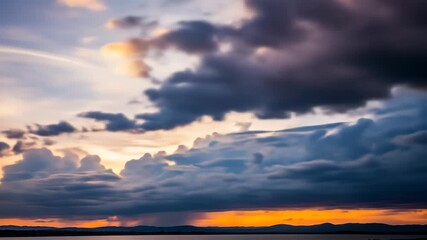 Dramatic sunset with sun rays piercing through dark clouds over a tranquil body of water - Powered by Adobe