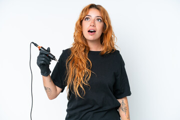 Tattoo artist caucasian woman isolated on white background looking up and with surprised expression
