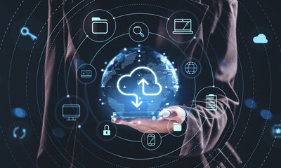 Cloud data storage and online network concept with holographic interface icons around digital globe held by a person in a business suit on dark background.
