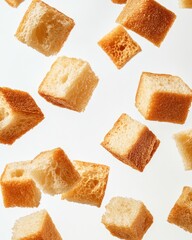 Crispy bread cubes levitate against white (1)