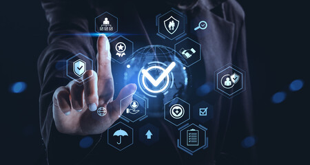 Businessman touching digital checkmark icon on futuristic hologram interface with technology security and compliance concept visualization elements.