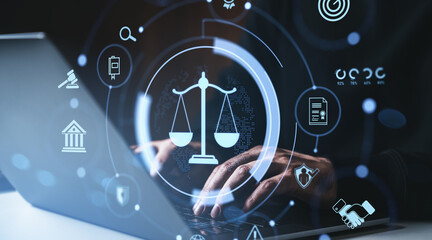 Digital justice law concept with futuristic hologram interface symbols over hands typing on laptop keyboard in dark environment background.