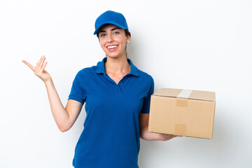 Delivery caucasian woman isolated on white background extending hands to the side for inviting to...