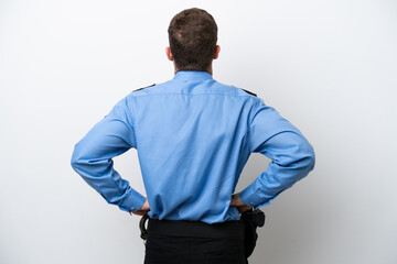 Fototapeta premium Young police caucasian man isolated on white background in back position