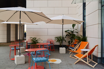 Chic Outdoor Lounge Area Featuring Vibrant Colorful Furniture and Stylish Umbrellas