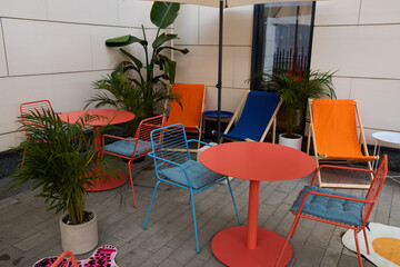 Experience a Vibrant Outdoor Lounge Area Featuring Colorful Chairs and Tables for Relaxation