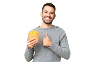 Young caucasian man holding fried chips over isolated chroma key background giving a thumbs up gesture