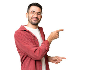 Young handsome caucasian man over isolated chroma key background pointing finger to the side and presenting a product