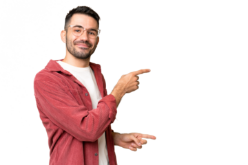 Young handsome caucasian man over isolated chroma key background pointing finger to the side and presenting a product