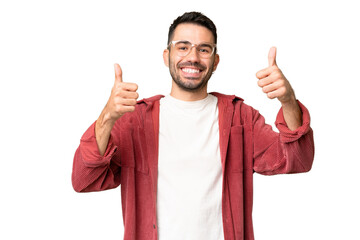Young handsome caucasian man over isolated chroma key background giving a thumbs up gesture