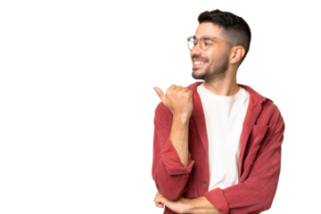 Young handsome caucasian man over isolated chroma key background pointing to the side to present a product
