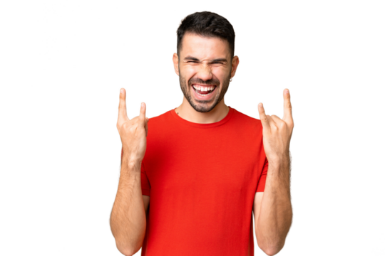 Young handsome caucasian man over isolated chroma key background making horn gesture