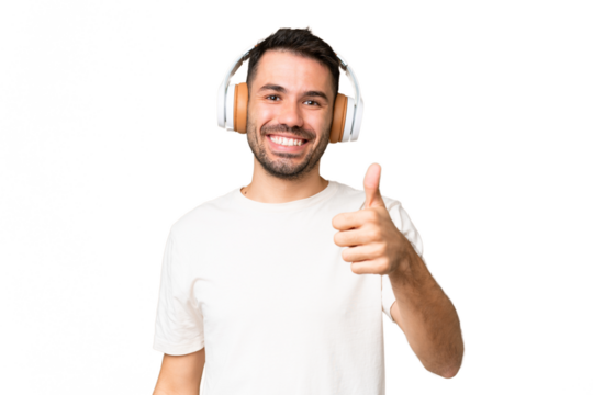 Young caucasian man over isolated chroma key background listening music and with thumb up
