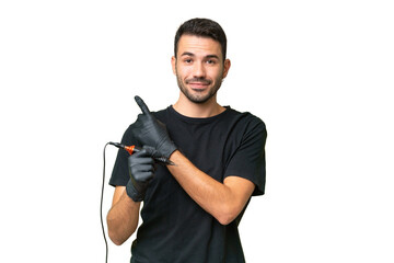 Tattoo artist caucasian man over isolated background pointing to the side to present a product