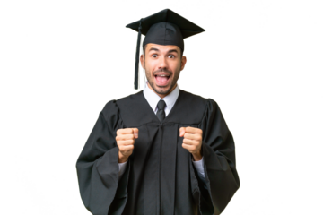 Young university graduate man over isolated background celebrating a victory in winner position