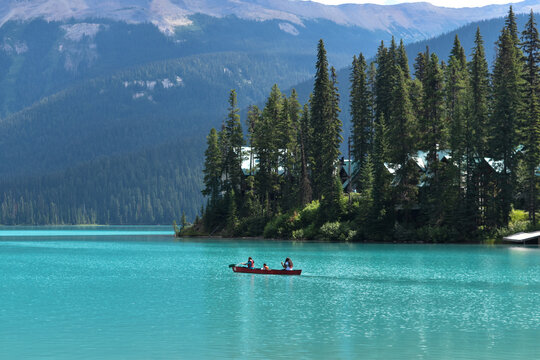 A couple rowing a boat on a mountain lake in Banff National Park, Canada