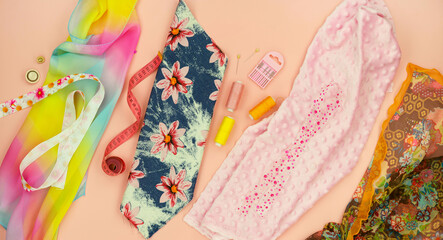 Various types of fabric for sewing. Fabric scraps and sewing accessories on a beige background.