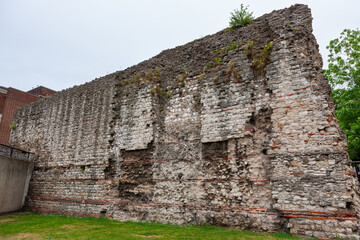 London Wall at Tower Hill, London, United Kingdom. Section of the defensive stone wall built by the Romans around the town of Londinium around AD 200. 