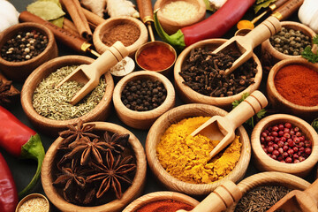 Colorful mix of herb and spice varieties: curry and coriander, turmeric and clove, paprika and pepper, cinnamon and garlic, cardamon and oregano	