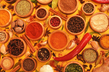 Colorful mix of herb and spice varieties: curry and coriander, turmeric and clove, paprika and...