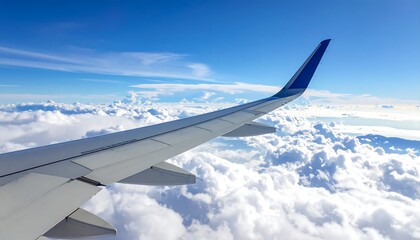 Obraz premium Airplane wing soaring above a sea of fluffy clouds on a sunny day.