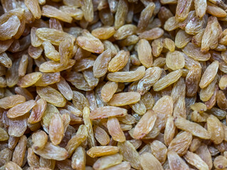 pile of golden raisins, also known as kishmish. Raisins are dried grapes,