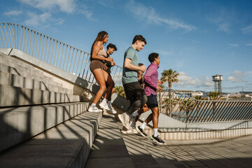 A group of five athletes on the stairs during a run