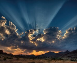 Dramatic sunset with sunbeams piercing through clouds over a landscape