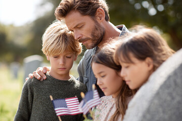 A poignant image shows a father with his three children at a gravesite, holding American flags, symbolizing remembrance, patriotism, family values, and grief.