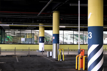A modern urban parking structure with colorful pillars, advanced safety, and efficient design