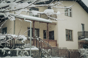 Exterior of house or cottage covered in deep snow in winter
